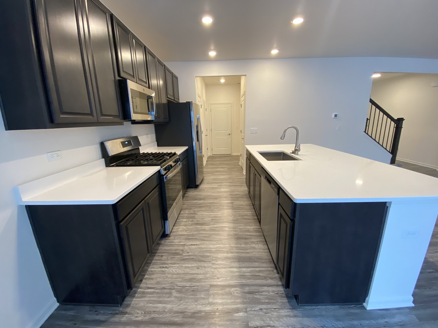 1208 Draper Road McHenry, IL 60050 - Photo 6 of 22 a kitchen with stainless steel appliances a sink stove and wooden cabinets