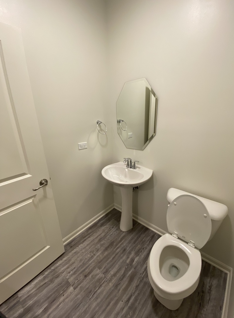 1208 Draper Road McHenry, IL 60050 - Photo 9 of 22 a bathroom with a toilet sink and mirror