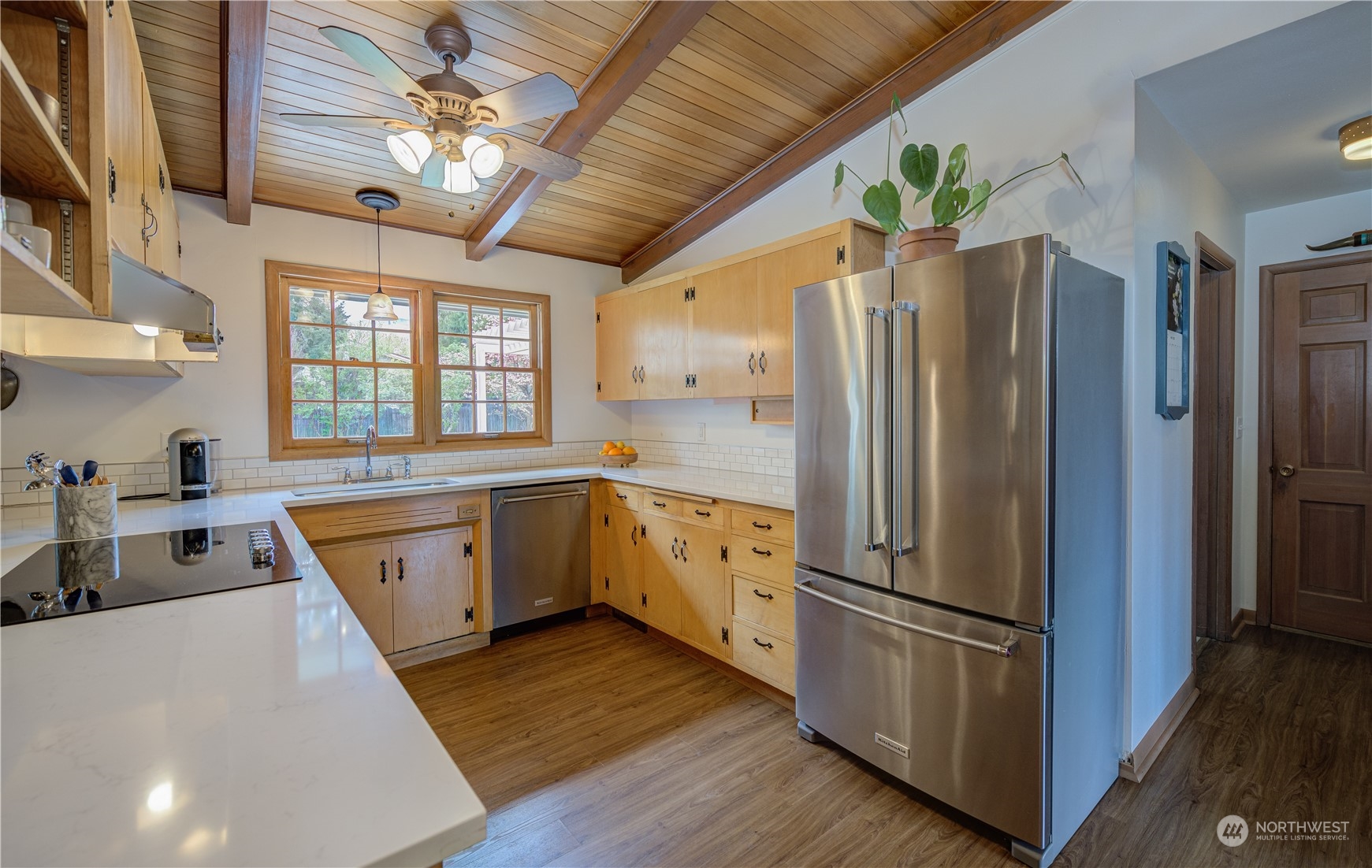1405 First Street Wenatchee, WA 98801 - Photo 21 of 40 a kitchen with stainless steel appliances granite countertop a refrigerator a sink dishwasher a stove and white countertops with wooden floor