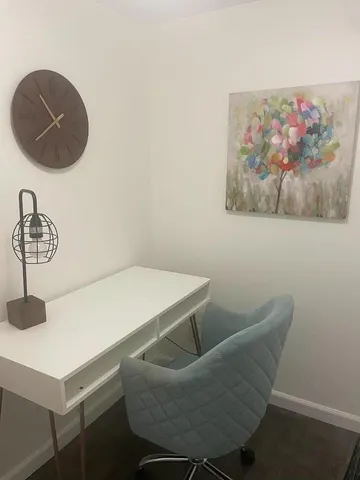 a view of a room with furniture and wooden floor
