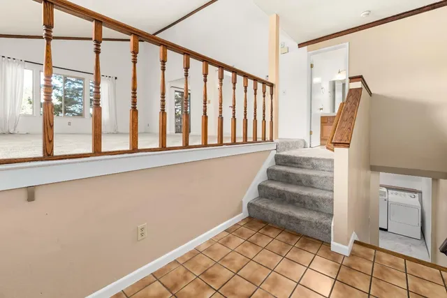 a view of staircase with white walls and a window