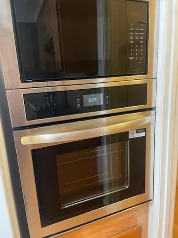 a stove top oven sitting inside of a kitchen