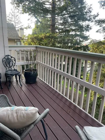a view of balcony with furniture and wooden deck