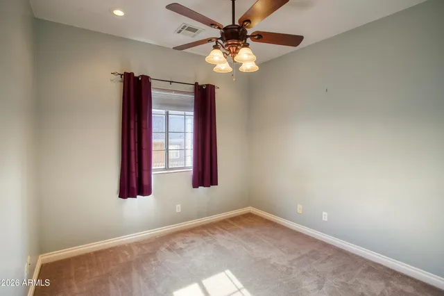 a bathroom with a granite countertop sink a mirror and a window