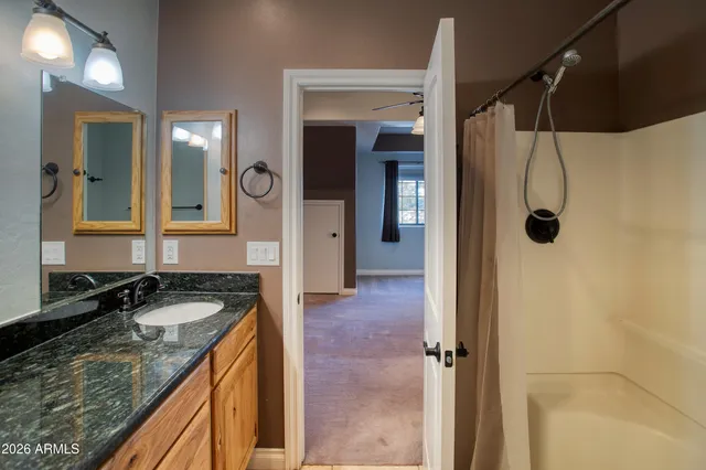 a spacious bedroom with a bed and a chandelier