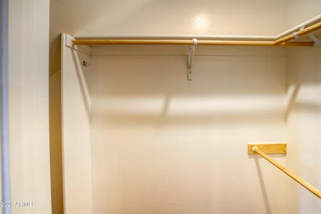 en empty room with windows and ceiling fan