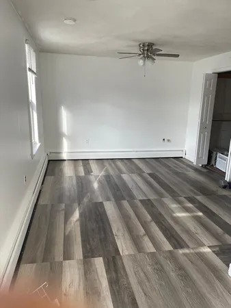 a view of a room with wooden floor