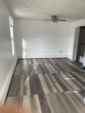 a view of a room with wooden floor