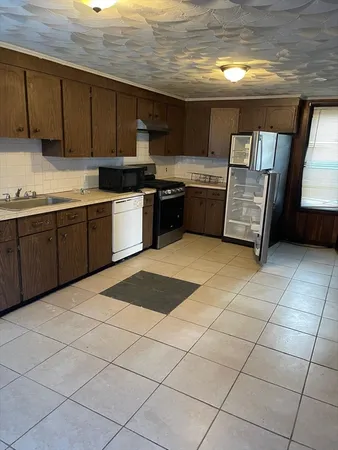 a kitchen with stainless steel appliances granite countertop a sink and cabinets