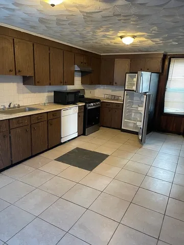 a kitchen with stainless steel appliances granite countertop a sink and cabinets