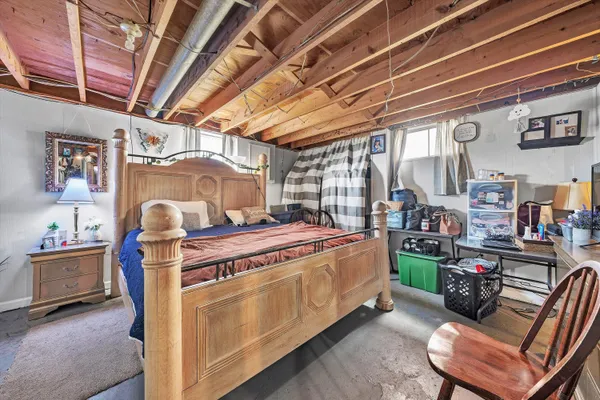 a bed room with a bed and a chair