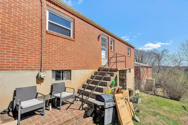 a view of a patio with couches chairs and potted plants