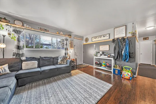 a living room with furniture and a wooden floor