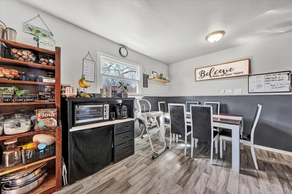 a view of a dining room with furniture and wooden floor