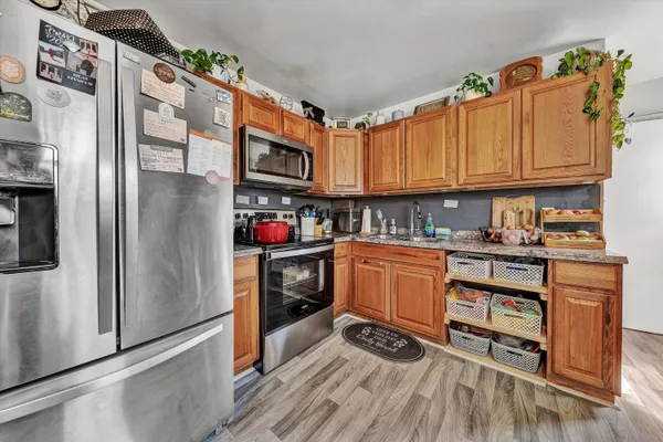 a kitchen with stainless steel appliances granite countertop a refrigerator stove and sink