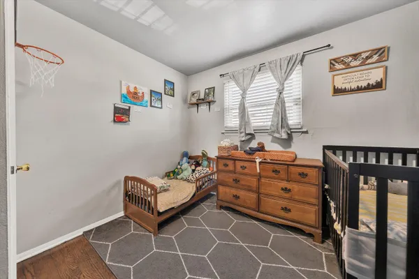 a bedroom with furniture and a window