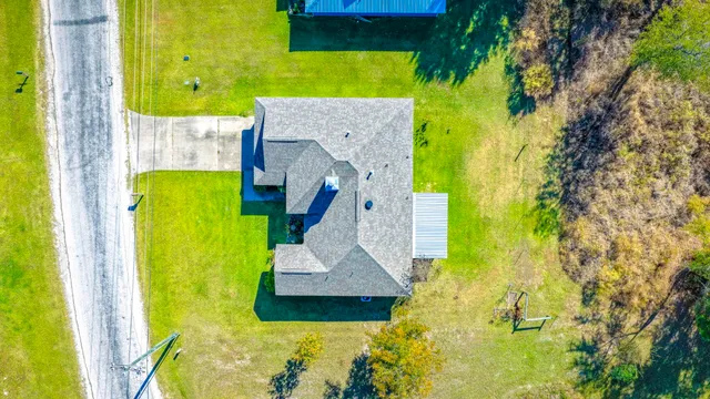 an aerial view of a house with a swimming pool