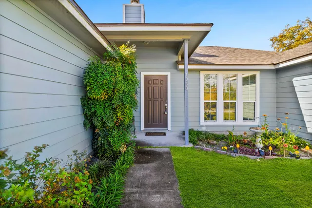a front view of a house with garden