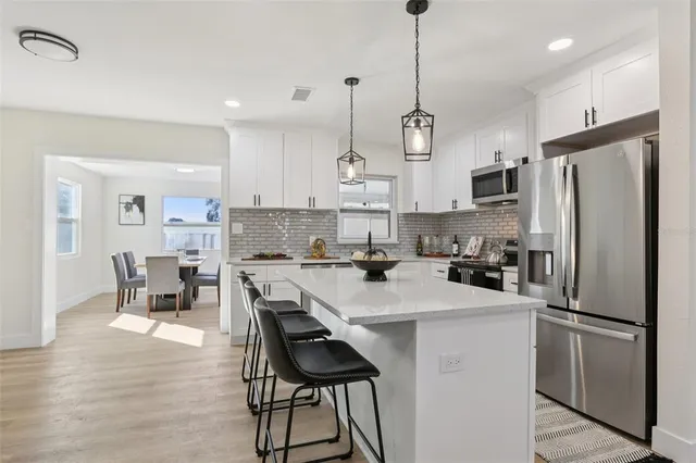 a view of a house with a backyard and a tree