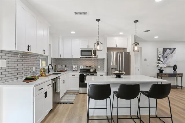 a view of backyard and wooden fence