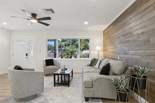 a living room with furniture and a potted plant