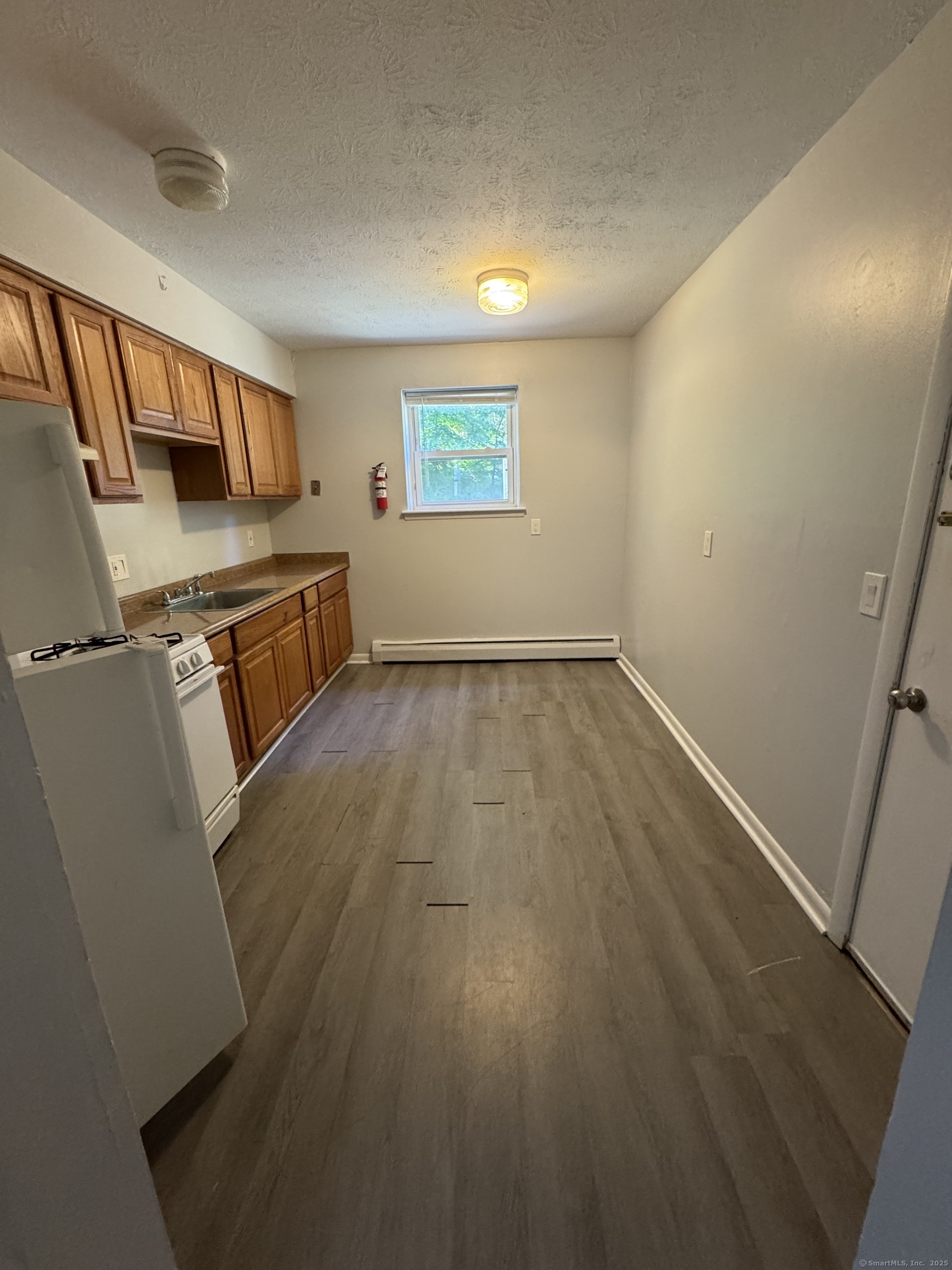 51 Bailey Street, Unit E1 New Haven, CT 06513 - Photo 1 of 1 an empty room with wooden floor and windows