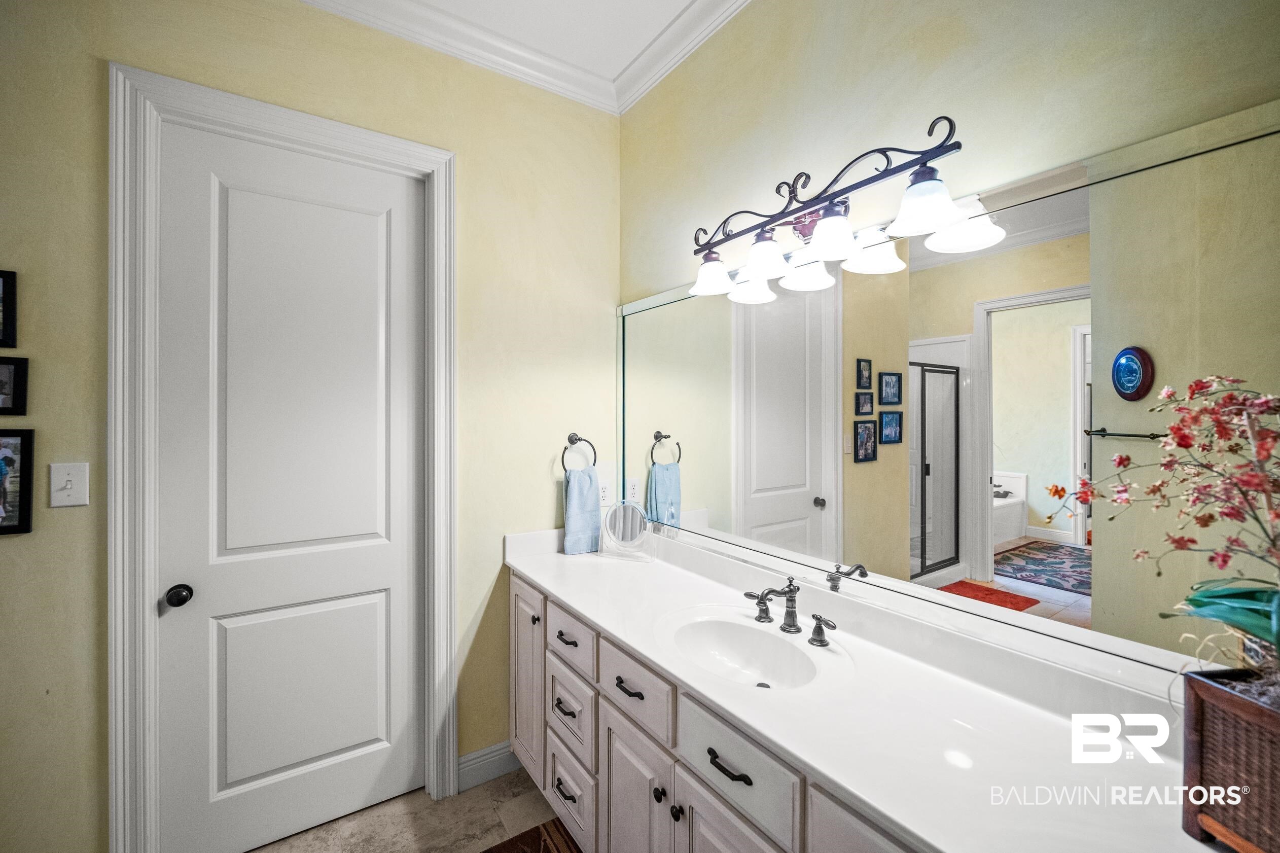 404 Peninsula Boulevard Gulf Shores, AL 36542 - Photo 22 of 51 Bathroom with vanity and ornamental molding
