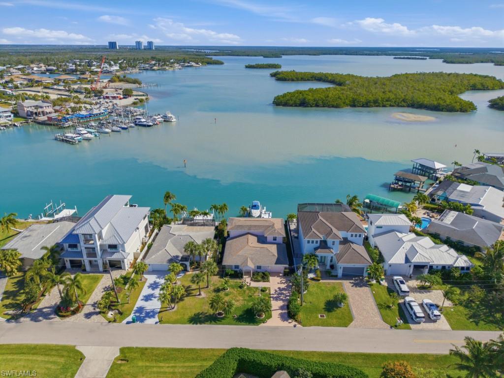 an aerial view of house with yard and lake view