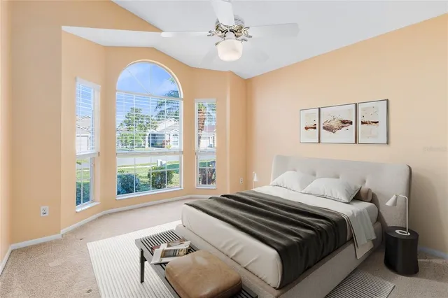 a bedroom with a large bed and a chandelier