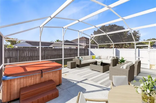 a outdoor space with the couches and dining table with the ocean view