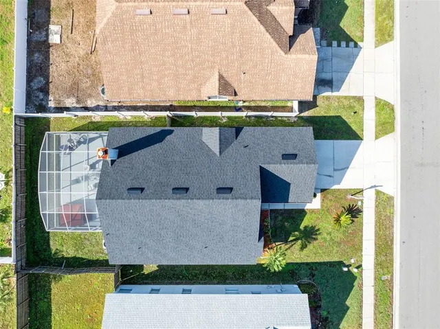 an aerial view of a house with a swimming pool