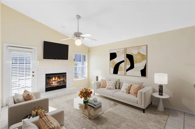 a living room with furniture a fireplace and a flat screen tv