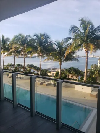 a view of a swimming pool and a lounge chair