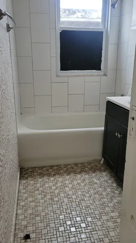 a bathroom with a bathtub and a shower