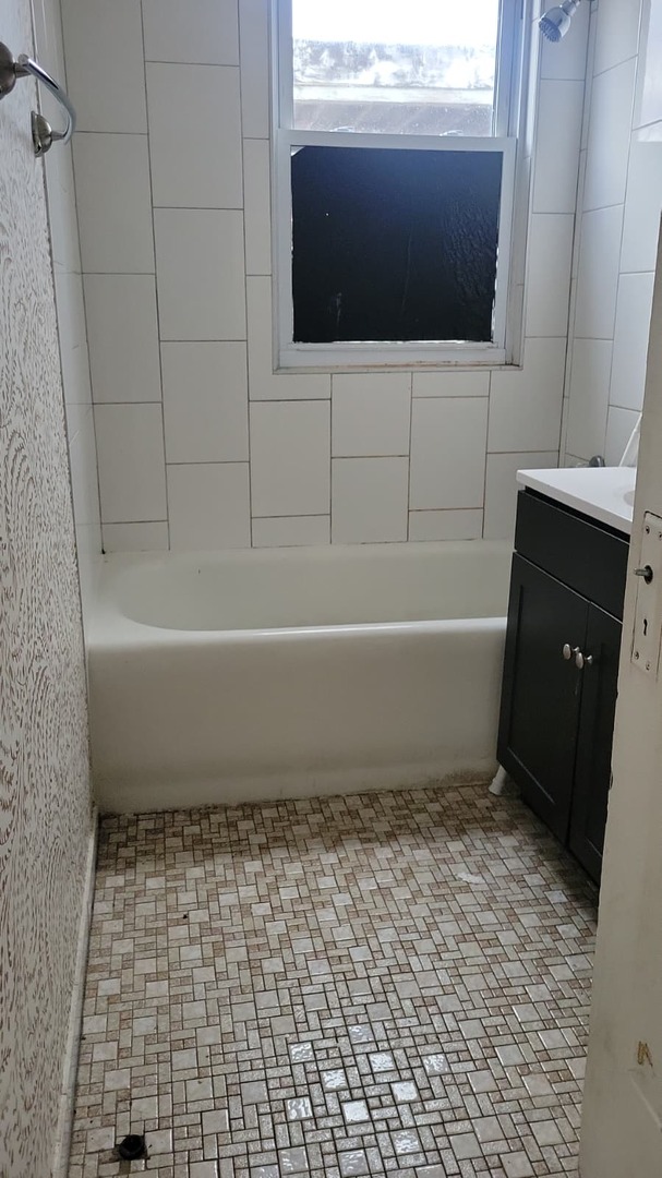 2700 West Albion Avenue, Unit 2 Chicago, IL 60645 - Photo 4 of 8 a bathroom with a bathtub and a shower