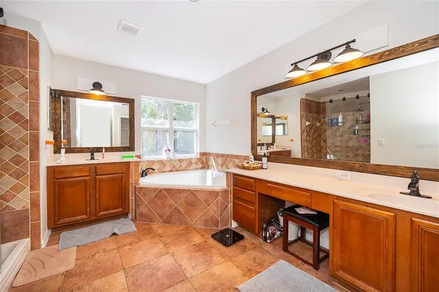 a large bathroom with a sink and a large mirror