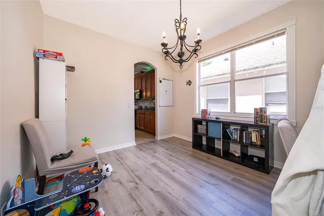 a living room with furniture and a chandelier