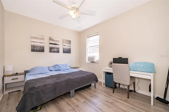 a bedroom with a bed and a desk