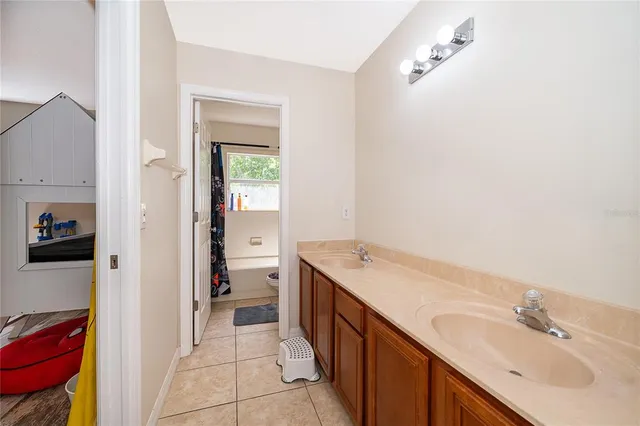 a spacious bathroom with a granite countertop sink and a mirror