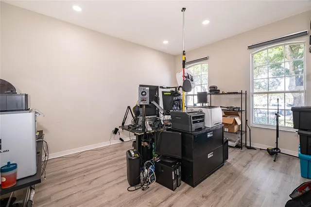 a view of a workspace with furniture and a window