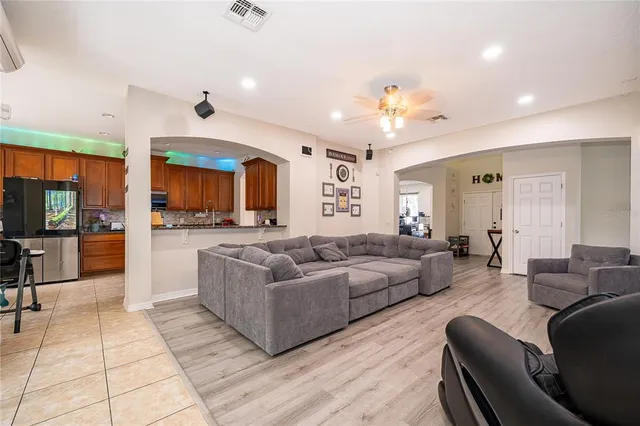 a living room with furniture and a chandelier