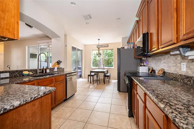 a kitchen with stainless steel appliances granite countertop a sink and cabinets