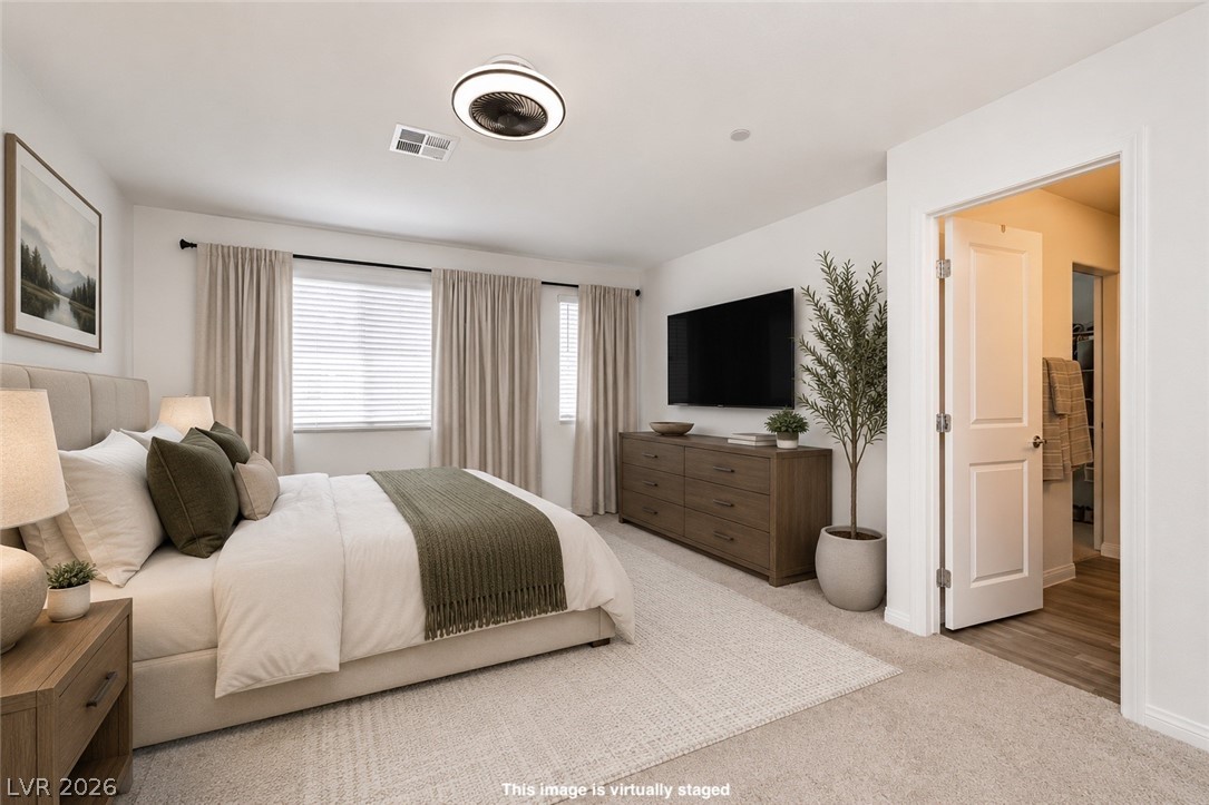 12369 Golden Wreath Road, Unit 2 Las Vegas, NV 89183 - Photo 9 of 19 An inviting bedroom offers ample natural light and a generous walk-in closet.