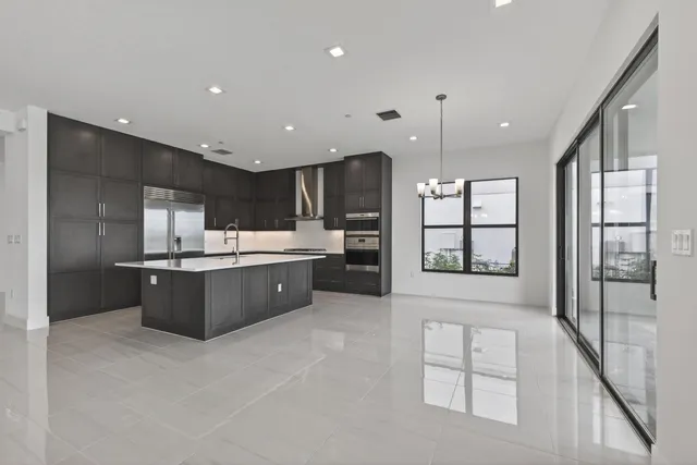a kitchen with kitchen island a sink appliances and cabinets