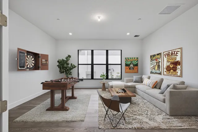 a view of an empty room with wooden floor