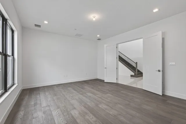 a bedroom with a large bed and a potted plant