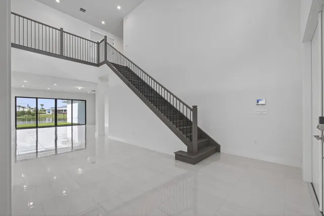a bathroom with a granite countertop bathtub shower sink vanity and toilet