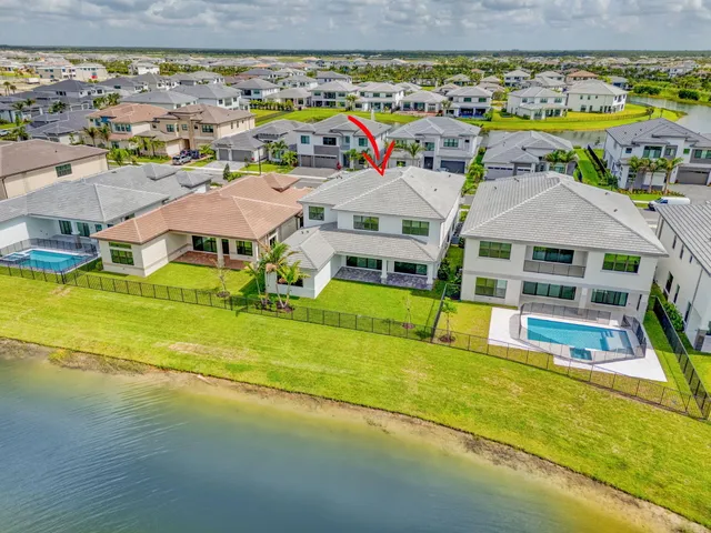 an aerial view of residential houses with outdoor space and swimming pool