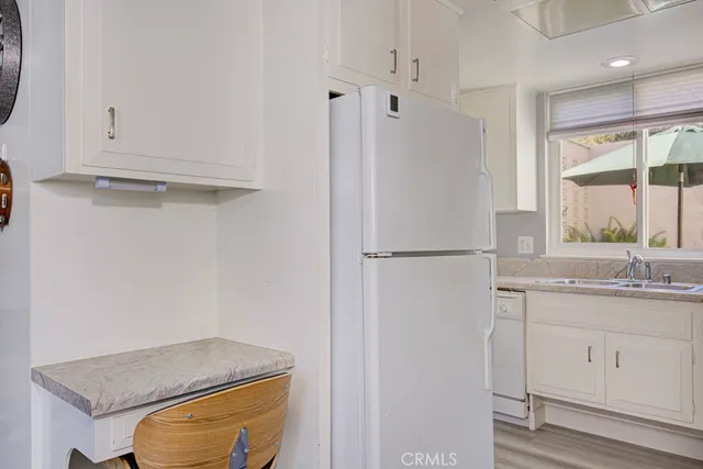 a kitchen with a sink a refrigerator and window