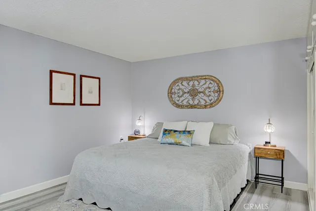 a bedroom with a bed and painting on the wall